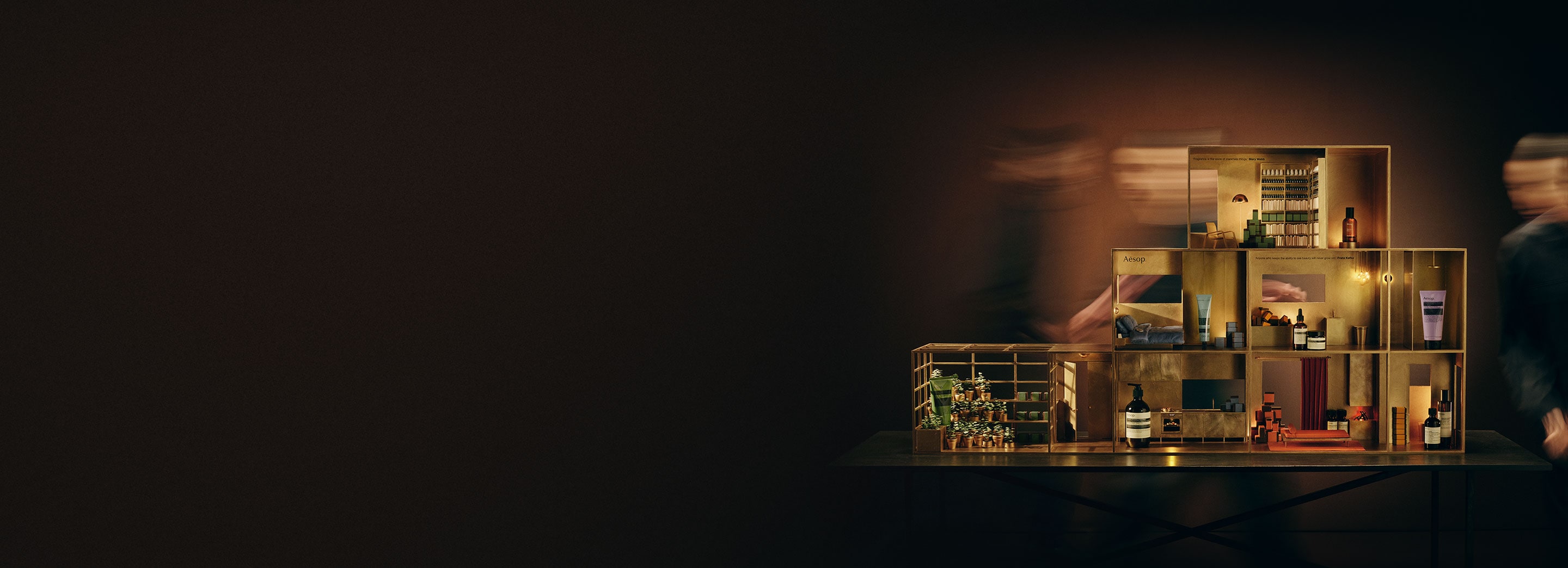 Festive miniature brass dolls house featuring a variety of Aesop products in every room.