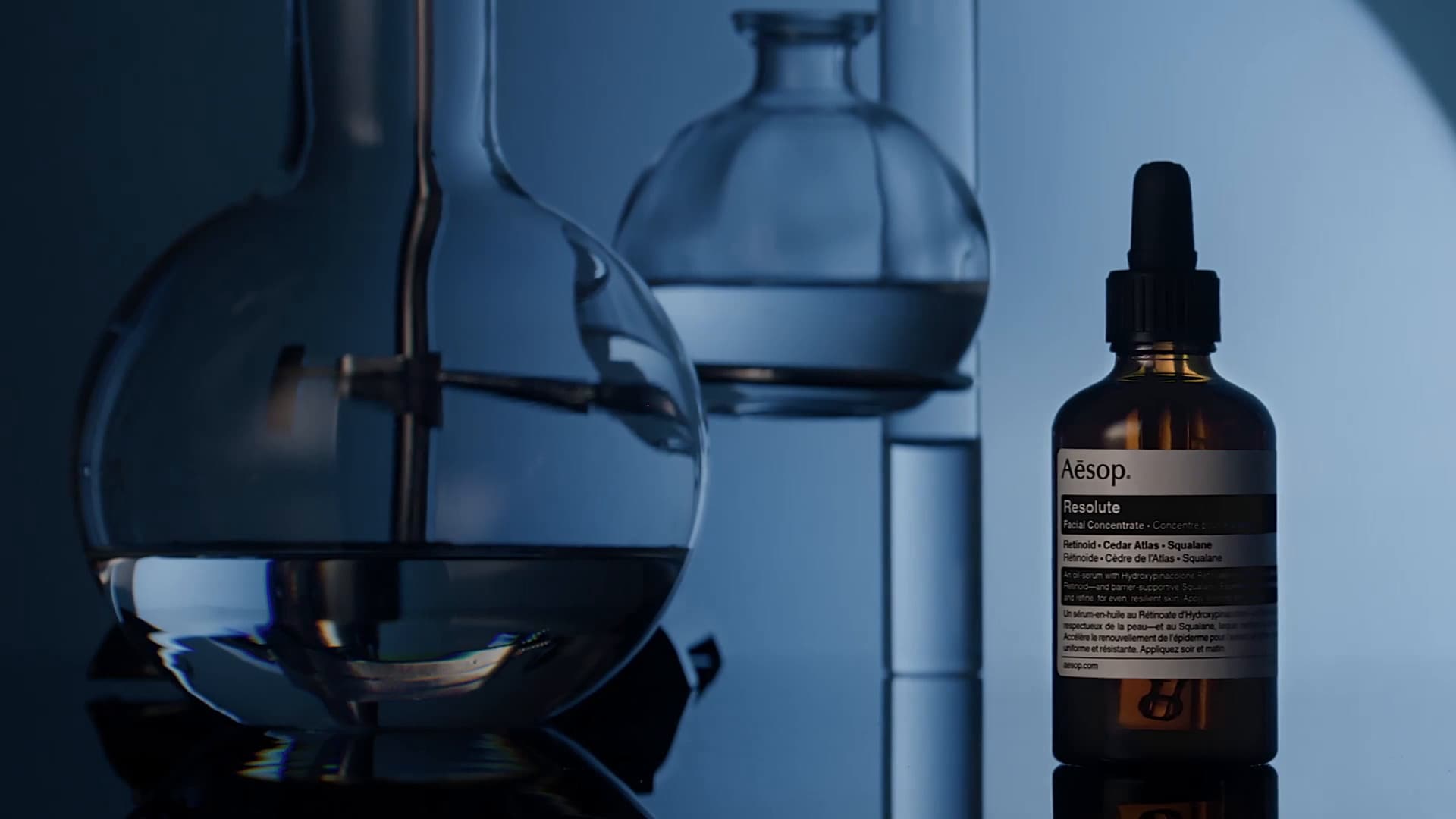 Two beakers with a bottle of Resolute