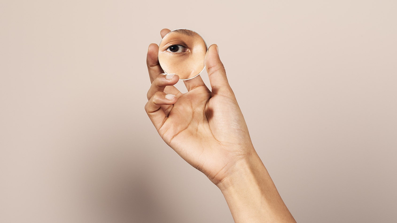 The reflection of a face in a small mirror