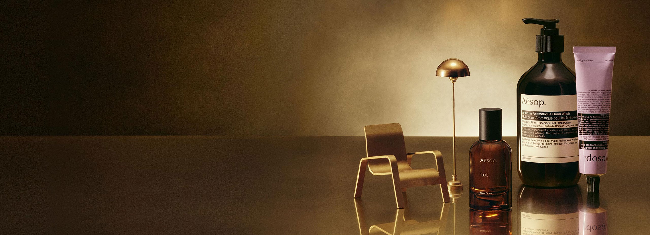 Aesop widely cherished gifts placed next to miniature brass furniture.