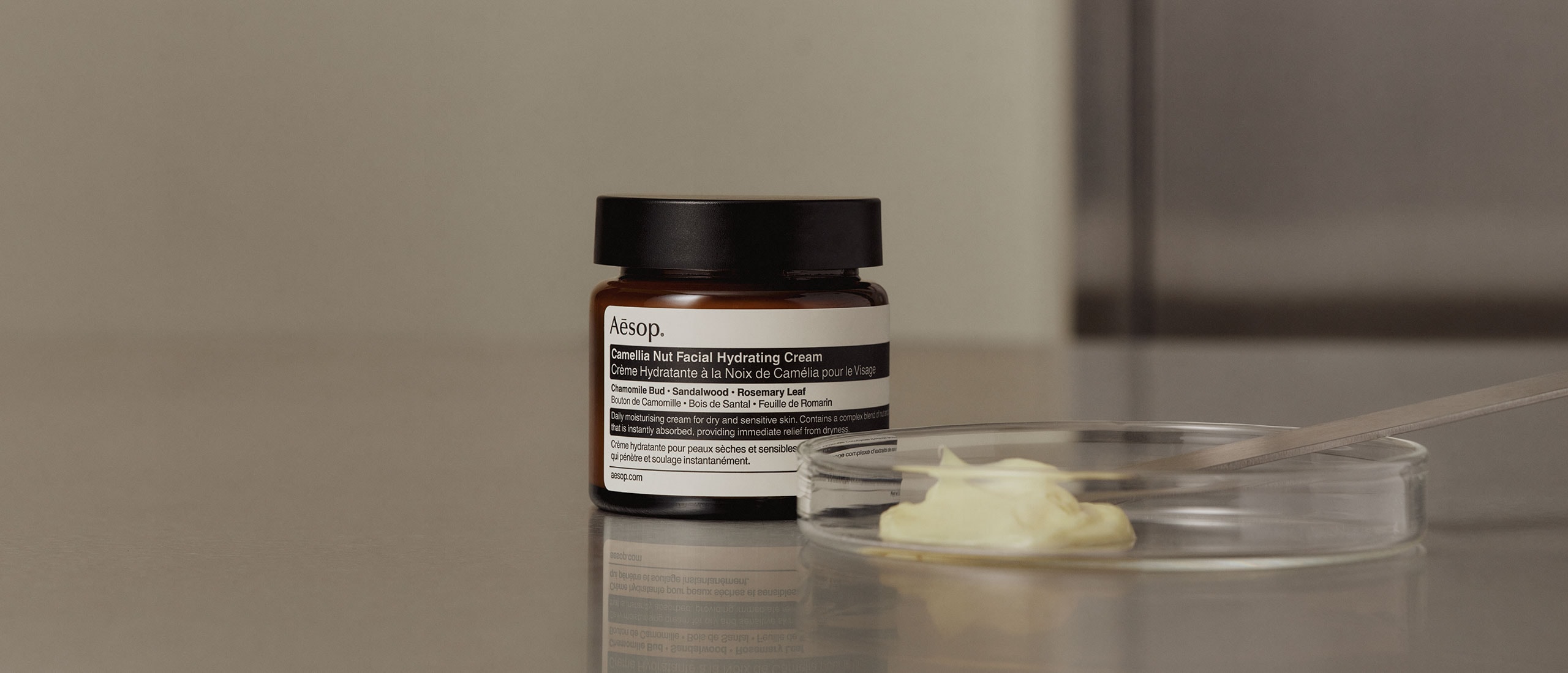 Camellia Nut Facial Hydrating Cream jar placed next to a petri dish