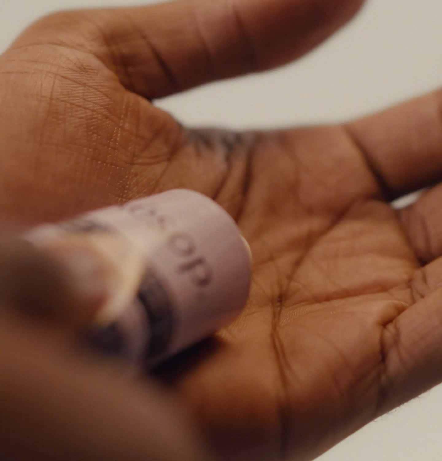 Dispensing Eleos hand balm on a palm