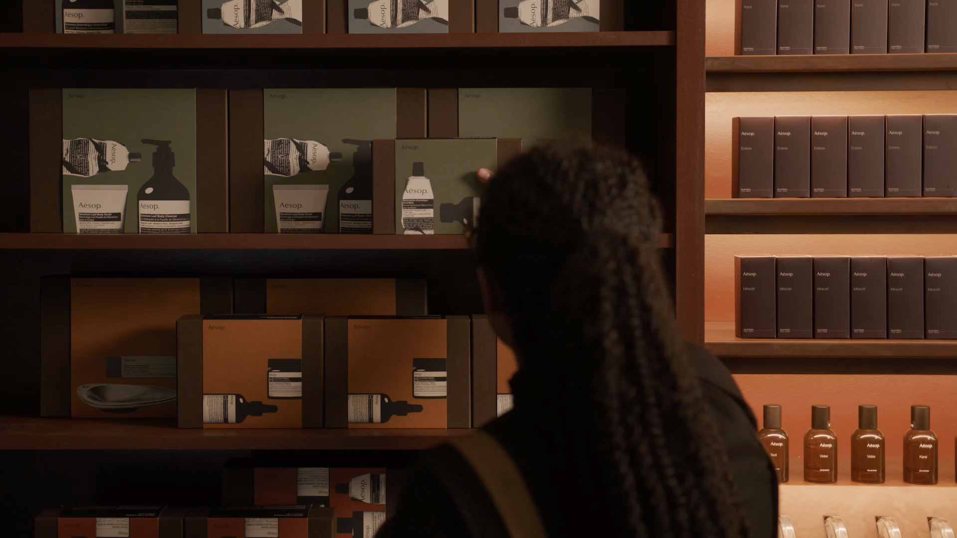 Aesop festive gift kits on display being picked a consultant.